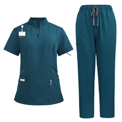 Flat lay of Caribbean Blue nursing scrubs featuring half-zip top and cargo pants