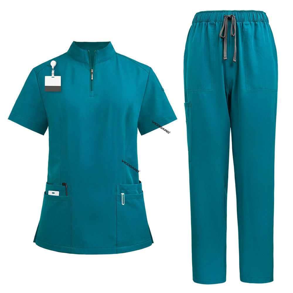 Flat lay of Teal surgical scrub set featuring zipper top and drawstring pants