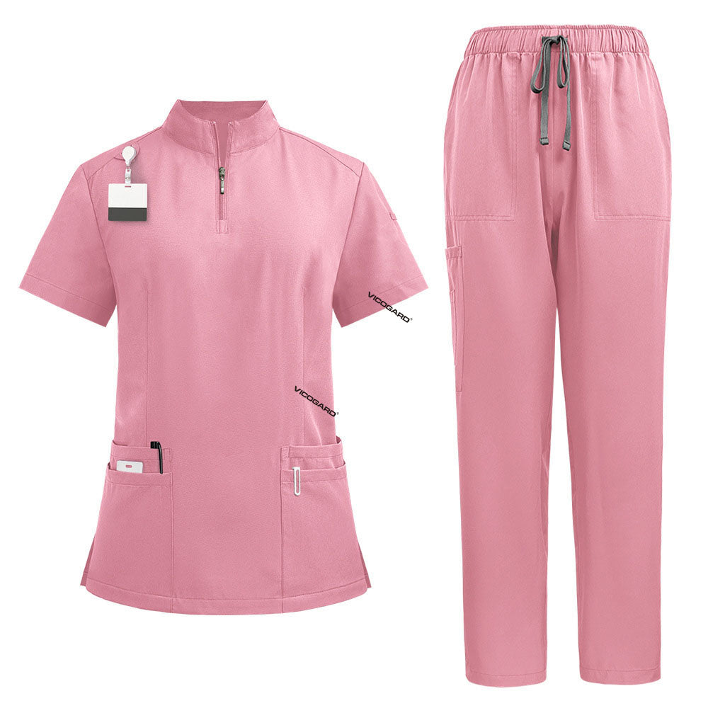Flat lay of Pink medical uniform set featuring zipper top and cargo pants